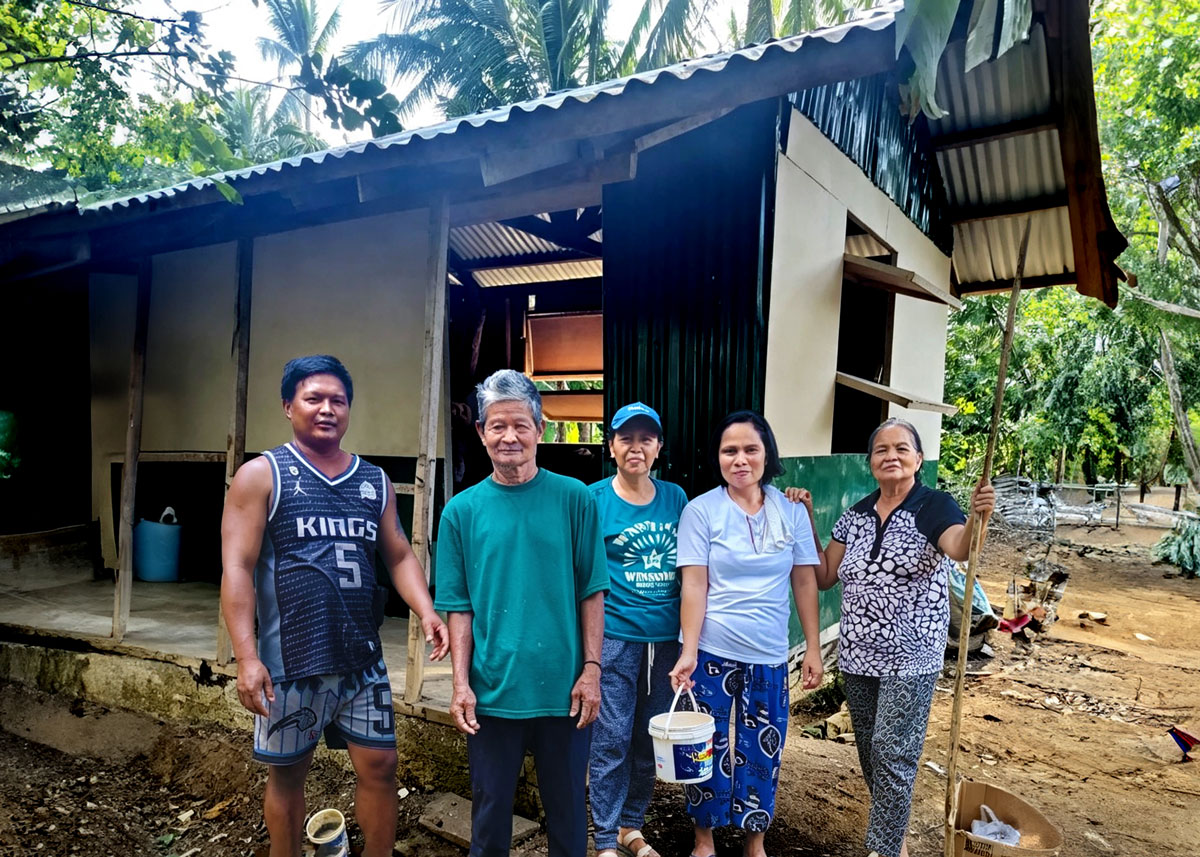 A family in the Philippines showing their new house